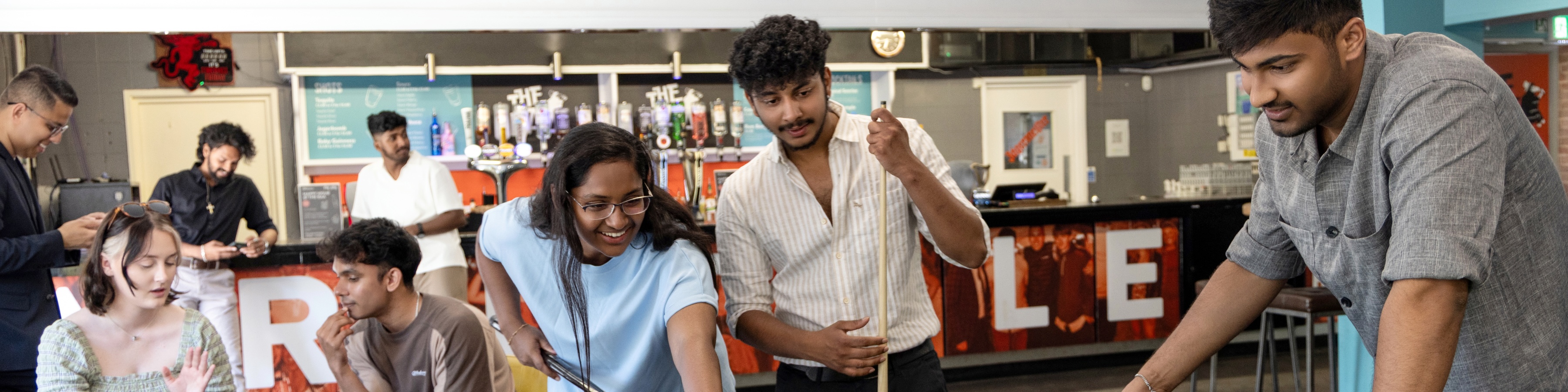 The 2025-26 officers playing pool in the bar.
